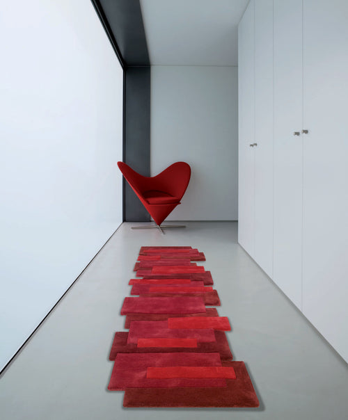 Red Angelo Pebbles cut-out shaped designer hallway runner rug in room with red love heart chair 