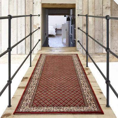 Traditional Lano Hall Runner Rug on raised walkway in front of rough sawn wood panel wall and open doorway