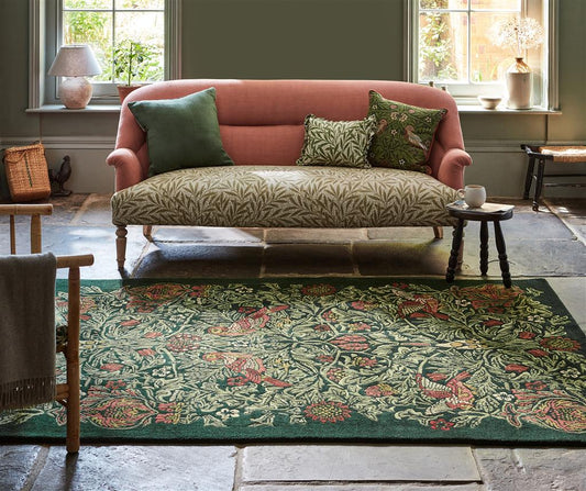 Morris & Co Bird Tump Green 128307 Rug in room on flagstone floor
 alternate image